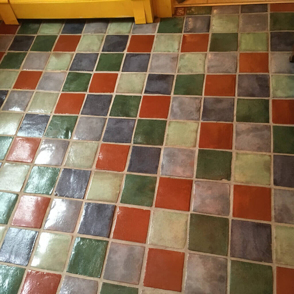 Dirty grout and natural tile floor after cleaning