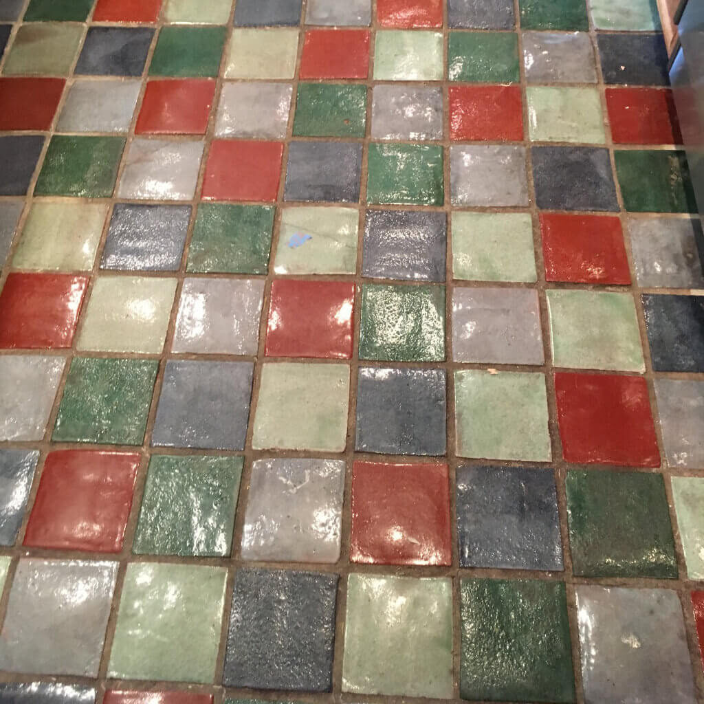Dirty grout and natural tile floor before cleaning